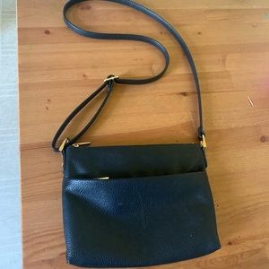 A small black messenger purse